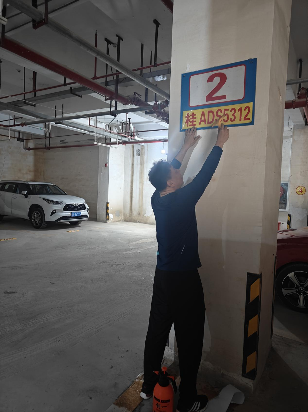 为明秀校区图书馆地下停车场粘贴号码牌